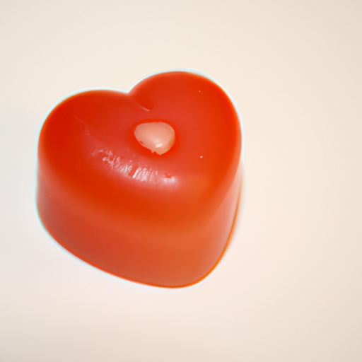 A small, red, heart shaped toilet soap bar